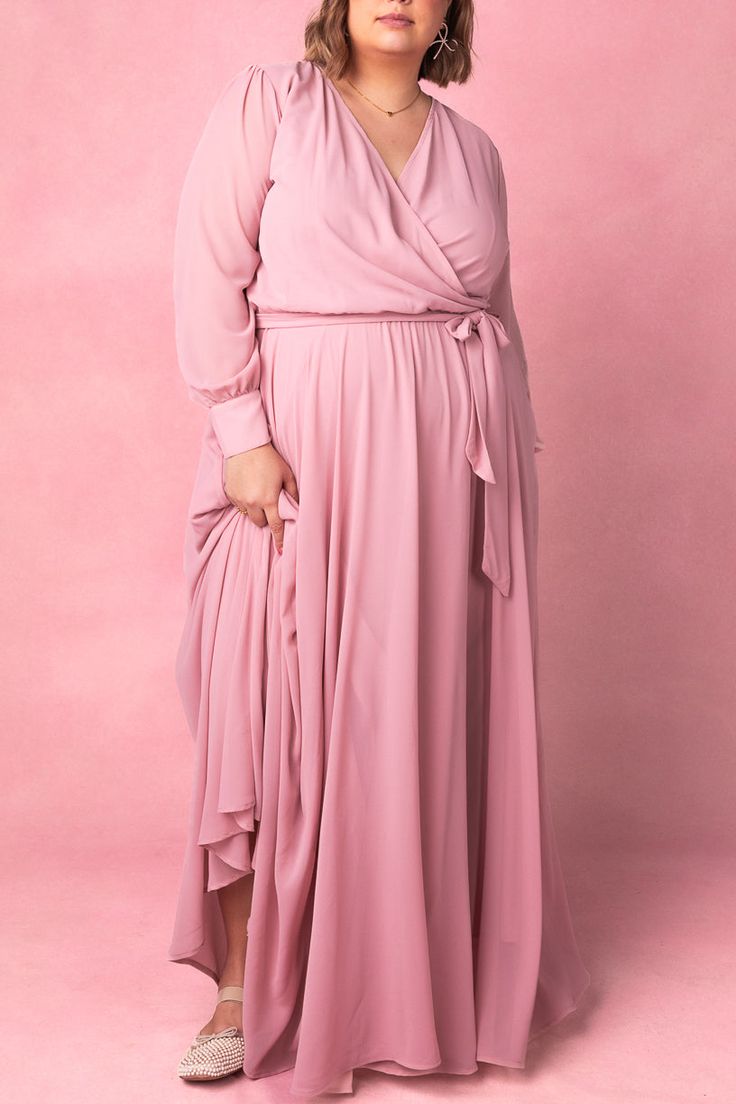 Say hello to the Andie Dress in Blush. Dare we say she's the perfect mother of the bride dress?! She's an amazing blend of style and comfort. This maxi dress features a soft pink base with a flattering faux wrap bodice and elastic waist for a flattering fit. The functional pockets and lined bodice and skirt add practicality, while the fabric's stretch makes it suitable for both maternity and nursing. With a v neckline and long, unlined sleeves, this dress is versatile AND chic. City Woman, Mother Of The Bride Dress, Mother Of The Bride Dresses, Bride Dress, Say Hello, Mother Of The Bride, Soft Pink, Nursing, The Bride