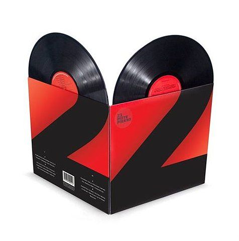 an open box with two black and red vinyl records inside, on a white background