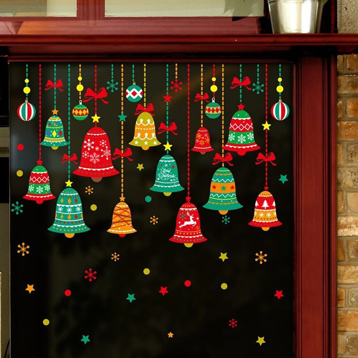 christmas decorations are hanging on the door to decorate with bells and snowflakes