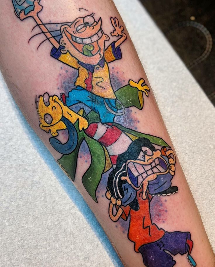 a cartoon character tattoo on the left forearm and leg, with other characters around it