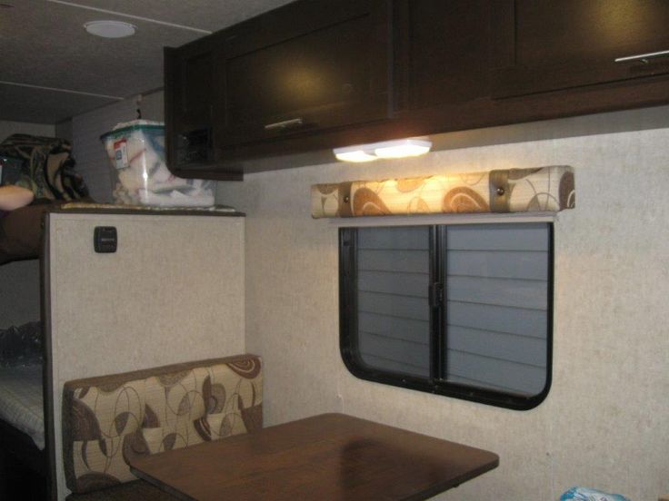 the inside of an rv with a table and chairs