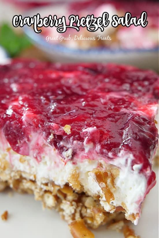 a close up of a piece of food on a plate with the words cranberry pretzels salad