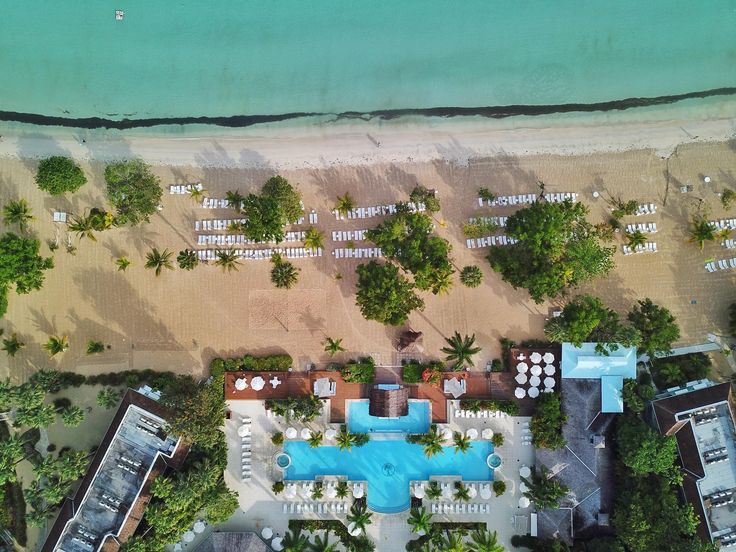 an aerial view of the beach and pool area