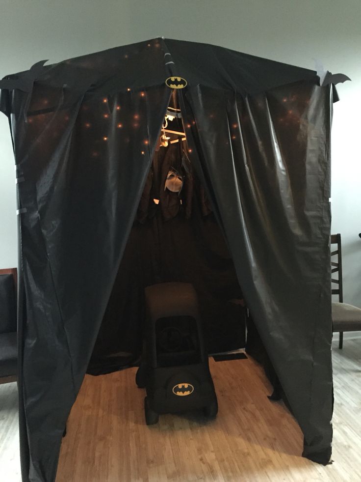 a batman themed room with a bat tent