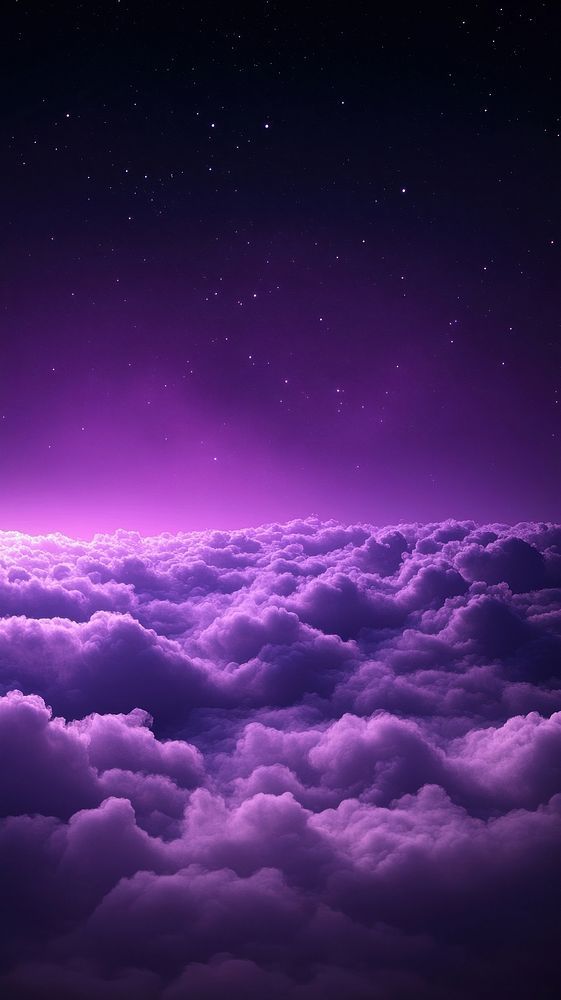 the sky is filled with purple clouds and stars in the distance, as seen from an airplane