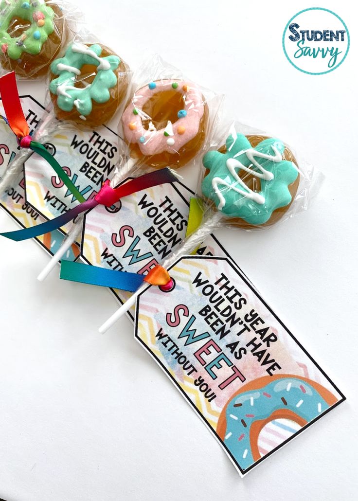 some donuts are wrapped in plastic and sitting on top of each other with ribbons