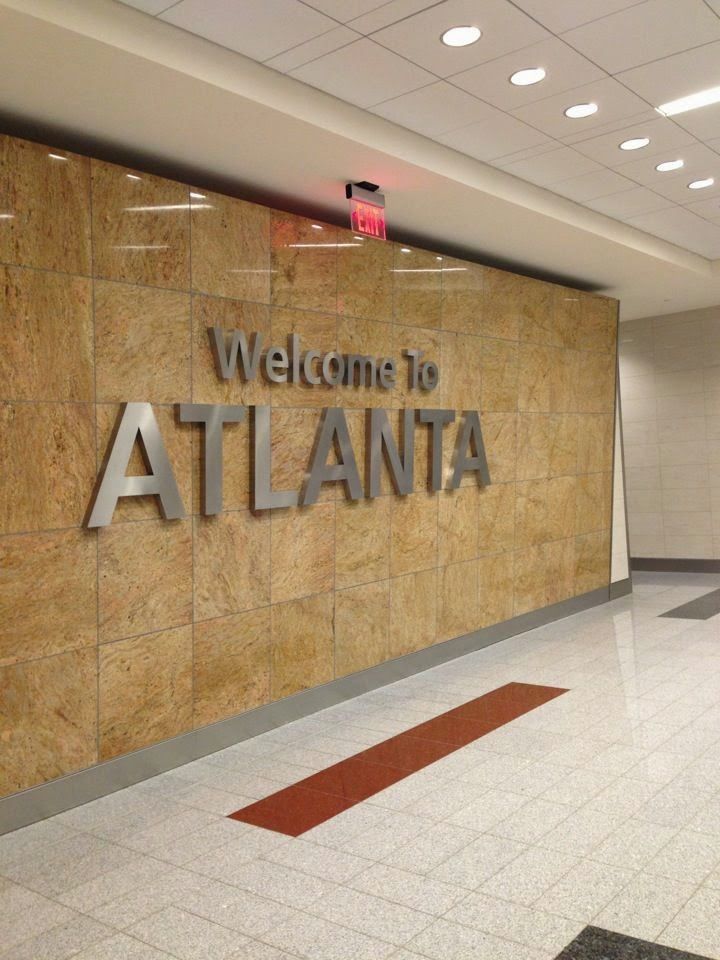 the welcome sign to atlanta is on the wall in the lobby at the airport terminal