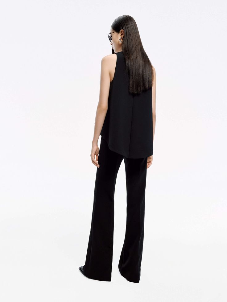 MO&Co. Women's Sleeveless Flared Jumpsuit A wide-leg jumpsuit works as a modern alternative to dresses. This black one is crafted from a comfy and structured, wide-leg silhouette, and layered front detail to create a tasteful and exclusive look. With a hook and elastic band at the back. Dress it up with heels and wear it casually with sandals on vacation, too. Features : - Wide leg silhouette, sleeveless design- Front layered detail, hook and elastic strap at the back- Back concealed zipper clos Sleeveless Pantsuit For Evening, Sleeveless Evening Pantsuit For Spring, Sleeveless Solid Pantsuit For Night Out, Sleeveless Sleek Evening Pantsuit, Sleek Sleeveless Evening Jumpsuits And Rompers, Sleek Sleeveless Jumpsuits And Rompers For Work, Sleek Sleeveless Jumpsuit For Work, Versatile Sleeveless Jumpsuits For Work, Sleeveless Black Pantsuit For Night Out