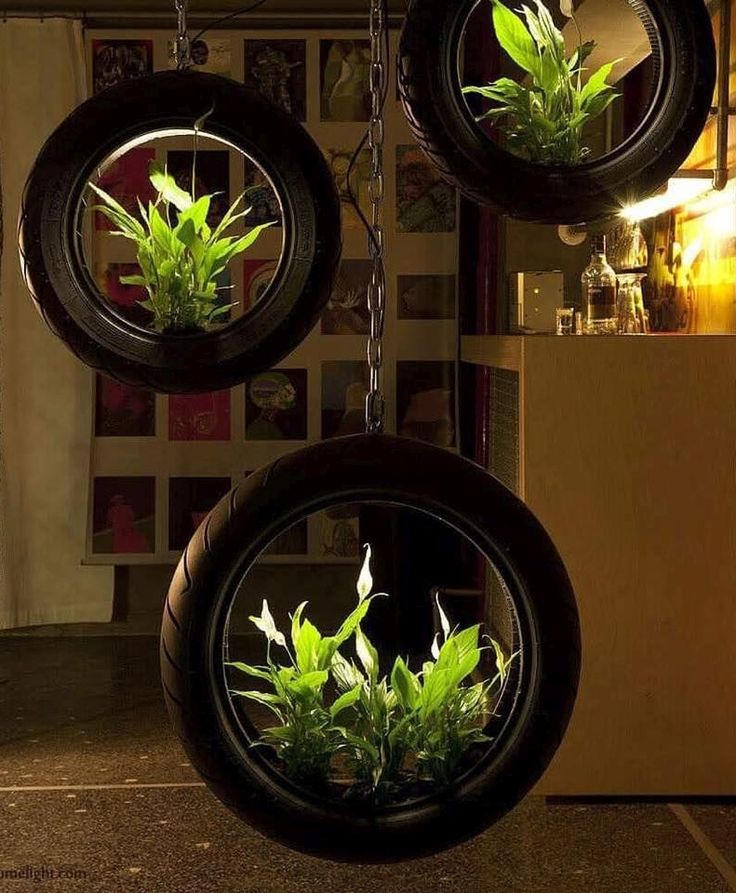 three hanging planters with plants in them