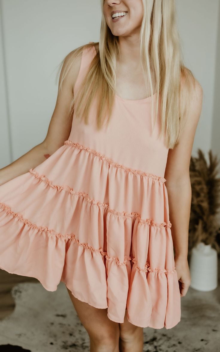 Step into carefree vibes with the Sundown Serenade Tiered Babydoll Dress. Made from textured crepe fabric, this boho-inspired dress features tiered ruffles for a playful, flowy silhouette that dances with every step. The adjustable tie straps allow for a customizable fit, making it perfect for sunny beach days or warm nights out. With its wide bottom sweep, this dress adds an effortlessly feminine touch to any occasion. Whether you're strolling through a farmers' market or heading to a casual su Boutique Aesthetic, Tiered Babydoll Dress, Western Boutique, Western Chic, Sunny Beach, Wide Brimmed Hats, Inspired Dress, Beach Days, Crepe Fabric