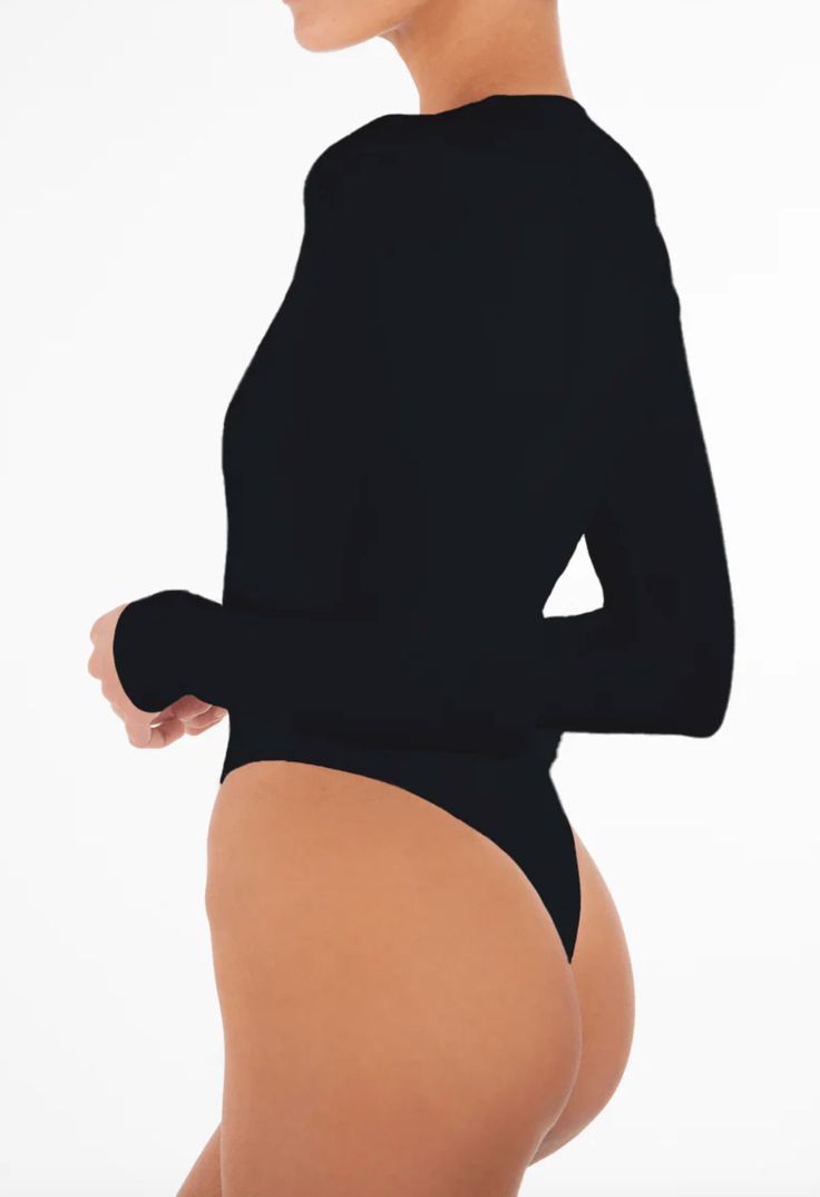 Designed by Eterne. Our long sleeve deep v bodysuit is the perfect addition to your fall/winter wardrobe. Wear on its own accessorized with your favorite layered necklace combo, or under your favorite blaze; this versatile bodysuit will become an instant staple in your day to night wardrobe essentials. Fit: Designed for a close fit. Runs true to size, take your normal size. Materials + Care: 89% Modal / 11% Lycra, Model is 177 cm/5'10" and is wearing a size S. Hand wash cold. Non-chlorine bleach Black Second-skin Turtleneck Bodysuit, Sleek High Stretch Long Sleeve Bodysuit, Black Turtleneck Bodysuit For Party, Chic Second-skin Bodysuit For Night Out, Sleek Long Sleeve Bodysuit, Sleek Long Sleeve Solid Color Bodysuit, Trendy Second-skin Long Sleeve Bodysuit, Sleek Long Sleeve Bodysuit For Night Out, Sleek Bodysuit For Night Out In Fall