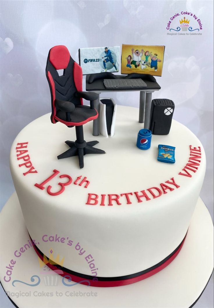 a birthday cake with a chair and computer on it