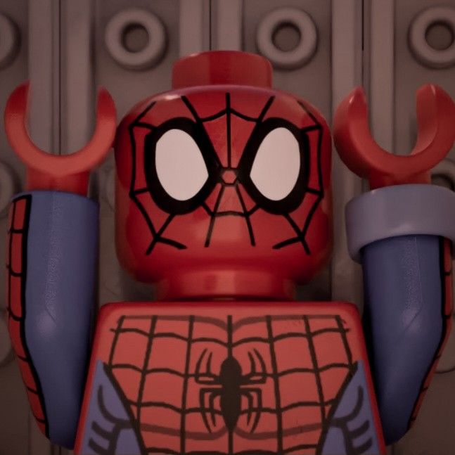 the lego spider - man character is standing in front of a wall