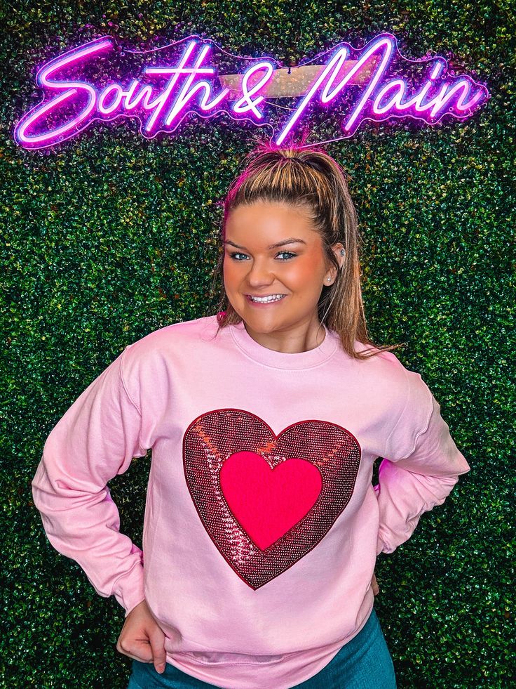 Indulge in the Valentine's spirit with our cute Red Sequin Heart Sweatshirt. The chenille and sequin accents add a stylish touch to this sweatshirt, making it the perfect choice for the season of love. Available in classic light pink, with a charming red and hot pink heart to complete the look. Unisex sizing and fit Pictured: Light Pink SPECIAL CARE - WASHING INSTRUCTIONS: Hand washing and air drying are always best for these items. Wash on delicate, cold, and inside out. Always air dry to preve Bag Patches, Sequined Sweatshirt, Heart Sweatshirt, Sequin Design, Converse With Heart, Womens Sweatshirts, Red Sequin, Cute Sweatshirts, Cozy Sweatshirts