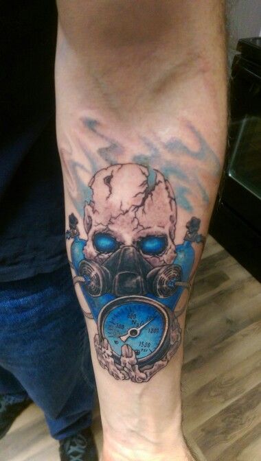 a man's leg with a clock and skull tattoo on his left calf area