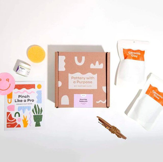 the contents of a craft kit including paper, scissors and other items are laid out on a white surface