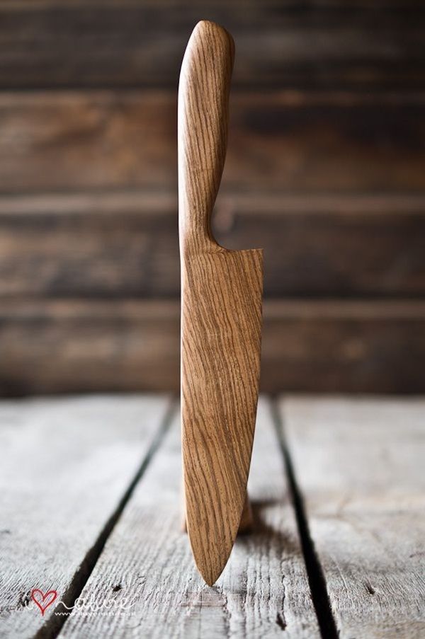 a wooden cutting board with a knife sticking out of it