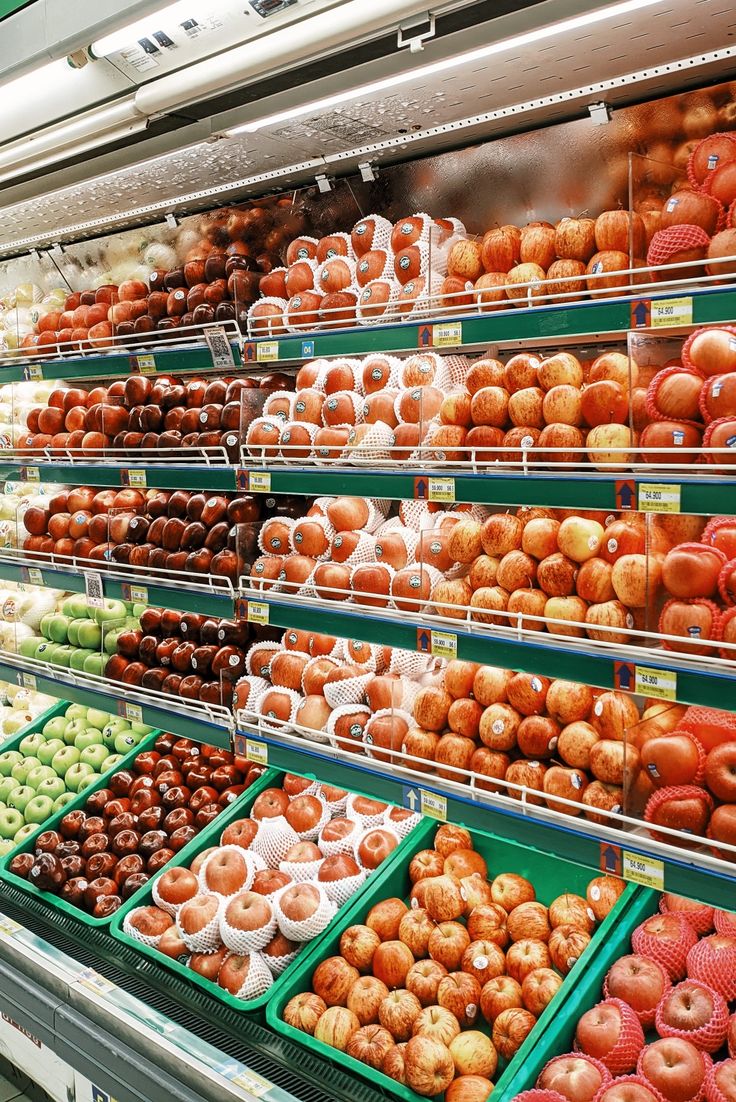 there are many different types of donuts on display in the store, including apples