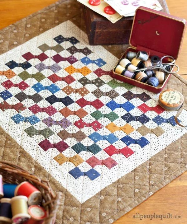 a quilted table top with scissors and thread