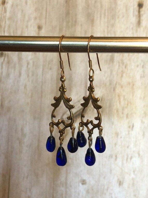 Bronze and blue dangle earrings.  Great for parties and/or elegant affairs. Blue Dangle Earrings, Blue Party, Party Earrings, Jewelry Earrings Dangle, Etsy Earrings, Dangle Drop Earrings, Dangle Earrings, Jewelry Earrings, Drop Earrings