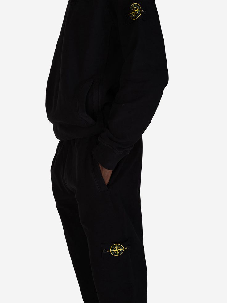 Level up your loungewear: Stone Island's black drawstring sweatpants aren't basic
 These Stone Island Black Drawstring Sweatpants redefine casual comfort. Crafted from a premium cotton blend that feels like a hug from a cloud, they'll become your new off-duty uniform. The classic silhouette and tapered leg with cuffed ankles give these sweats a polished look that goes beyond the couch. The adjustable drawstring waistband ensures a perfect fit, the eye-catching emblem adds a touch of exclusivity. Black Joggers With Logo For Loungewear, Black Logo Sweatpants For Loungewear, Black Sweatpants With Logo Detail For Loungewear, Stone Island Streetwear, Black Loungewear Joggers With Logo Detail, Stone Island Jeans, Stone Island Beanie, Stone Island Knit, Stone Island Sweatshirt