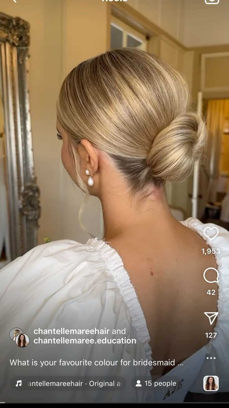 the back of a woman's head with her hair in a low bun