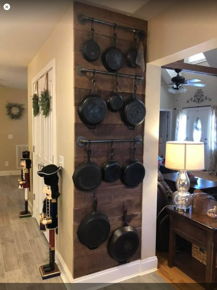 an entry way with pots and pans hanging on the wall