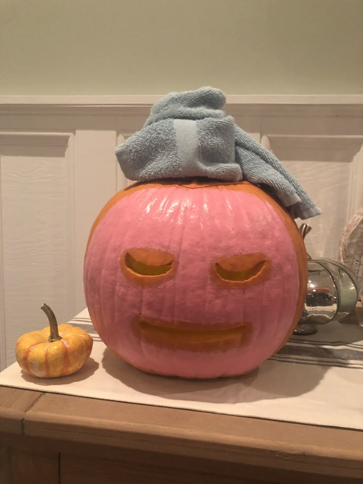 a pumpkin with a towel on top of it