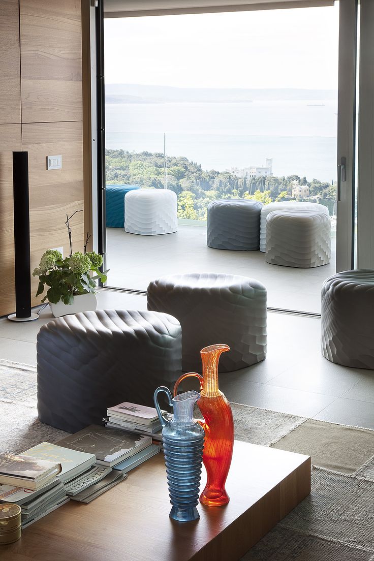 a living room filled with furniture and a large window