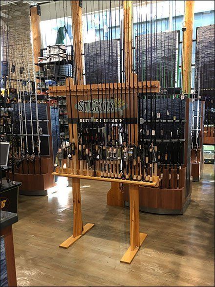 the wine rack is full of bottles in the store's tasting area, and there are many other items on display