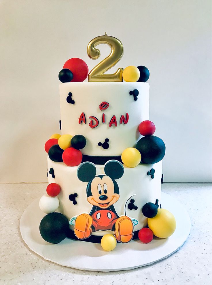 a mickey mouse birthday cake with the number two on top