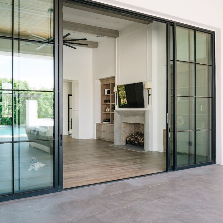 a living room with glass doors and a fireplace