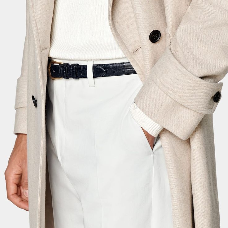 Mid-thigh length overcoat in sand, featuring wide peak lapels and natural shoulders. Double-breasted closure, patch pockets, and inside pockets for functionality. Single vent, lined, with martingale belt for style. Perfect White Shirt, Polo Cardigan, Cashmere Fabric, Tuxedo Shirts, Vest Coat, Casual Vest, Sweaters Online, Travel Shirts, Knit Shirt