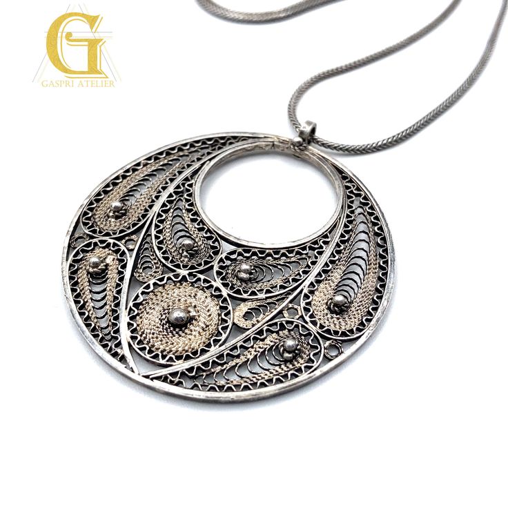 "This pendant is one of our new vintage collection items I discovered recently from another part of my family. The pendant is a handmade filigree work from one of our family master jewelers and was revived in order to present this exceptional art. Each handmade element was made with love, passion and personal touch.  Making this pattern starts with immaculate imagination and requires extensive and precise work. When looking at this element it is hard to believe that each item was 100% handmade.  This pendant is one of our families filigree handmade vintage collections that symbolizes Full Moon. Necklace Length 20\" Pendant size: 40 mm Pendant Weight: 7.8 gr Total Weight: 10.4 gr" Antique Jewelry With Intricate Flower Pendant, Antique Jewelry With Large Flower Pendant, Antique Flower Pendant Jewelry With Large Pendant, Vintage Collection Large Pendant Jewelry, Ornate Flower Pendant Jewelry With Intricate Design, Ornate Jewelry With Intricate Flower Pendant, Vintage Necklaces With Artistic Design For Gift, Artisan Pendant Jewelry From Vintage Collection, Artisan Pendant Jewelry For Vintage Collection