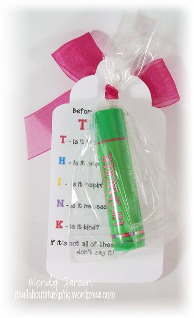 a green pen wrapped in plastic with pink ribbon