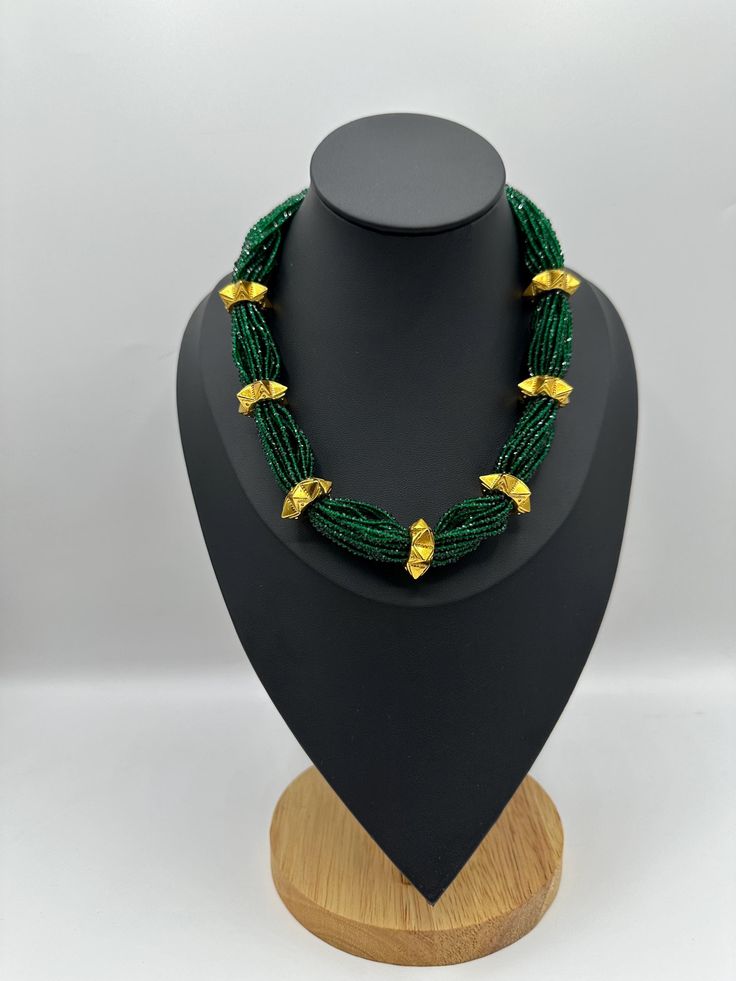 Discover the perfect blend of tradition and elegance with our Gold Plated Mini Naugedi Hydro Potey Necklace. This exquisite piece is designed to complement any outfit, adding a touch of sophistication and charm. Gold Beaded Emerald Necklace, Green Gold-plated Kundan Necklace For Festivals, Green Beaded Necklace With Gold Beads As Gift, Green Gold Plated Kundan Necklace For Festivals, Elegant Green Beaded Necklaces With Gold Beads, Gold Emerald Necklace With Round Beads For Festive Occasions, Elegant Green Beaded Necklace With Gold Beads, Green Necklace With Gold Beads As Gift, Green Necklace With Gold Beads For Gift