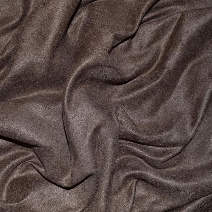 a close up view of a brown fabric with very soft folds and wrinks