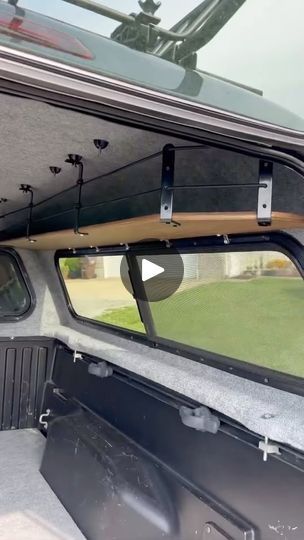 the inside of a vehicle with its door open and windows opened to show an empty field