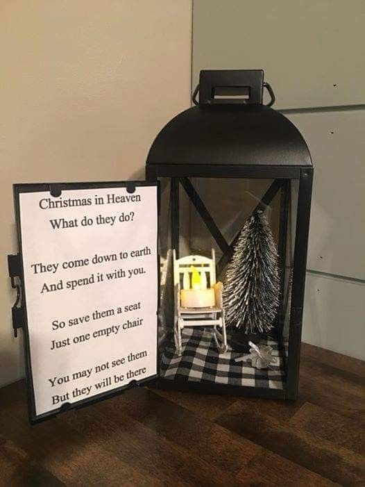 a christmas lantern with a poem written on it next to a miniature chair and tree