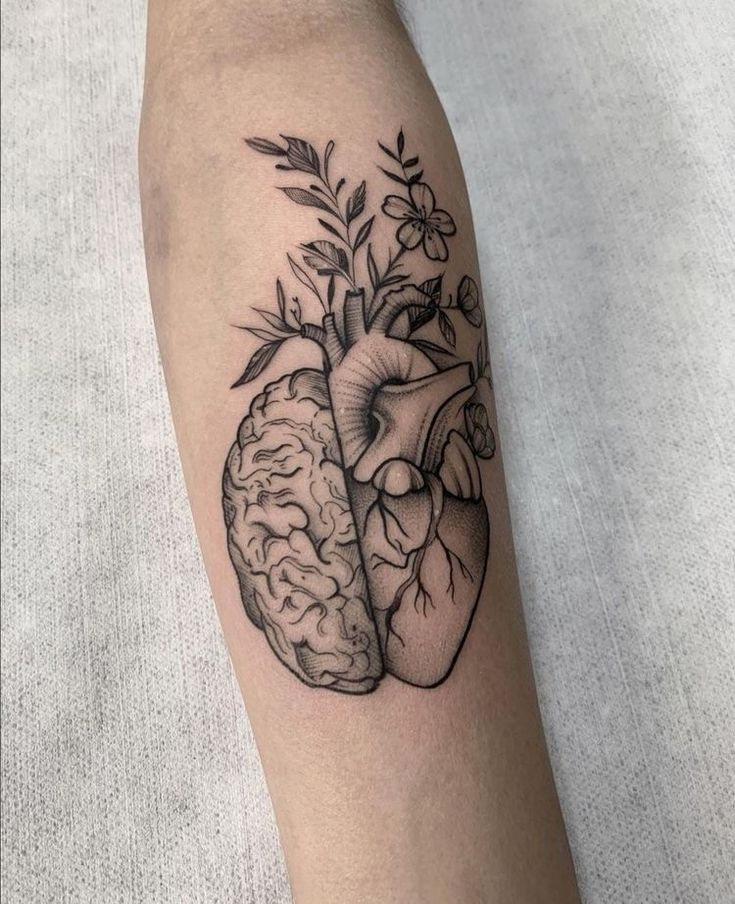 a black and white tattoo of a human heart with a plant growing out of it