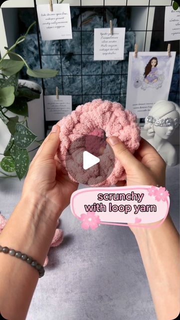 a person holding a pink doughnut in their hand with the words semfy with loop yarn on it