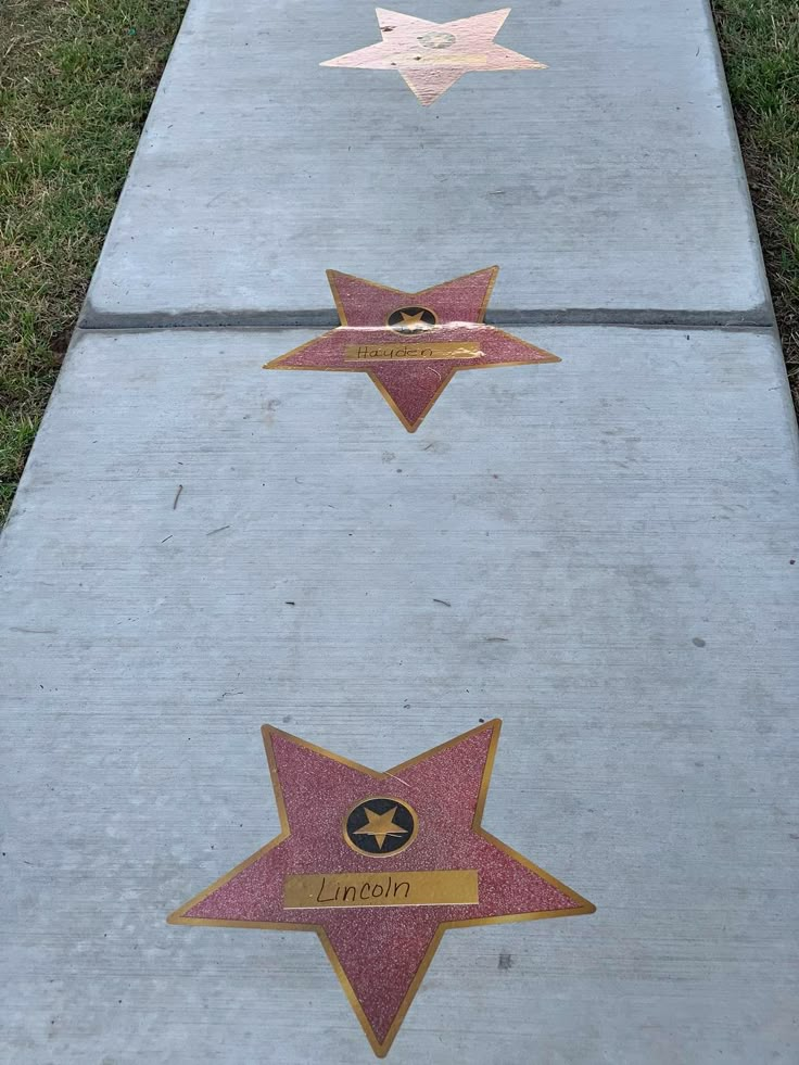 three stars are placed on the sidewalk near each other