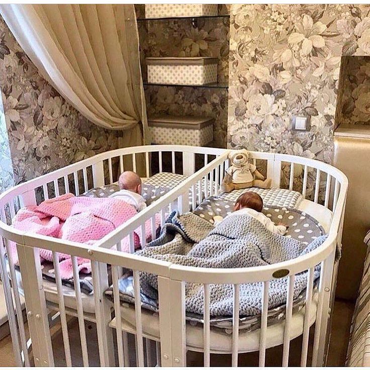 there is a baby in a crib next to a bed