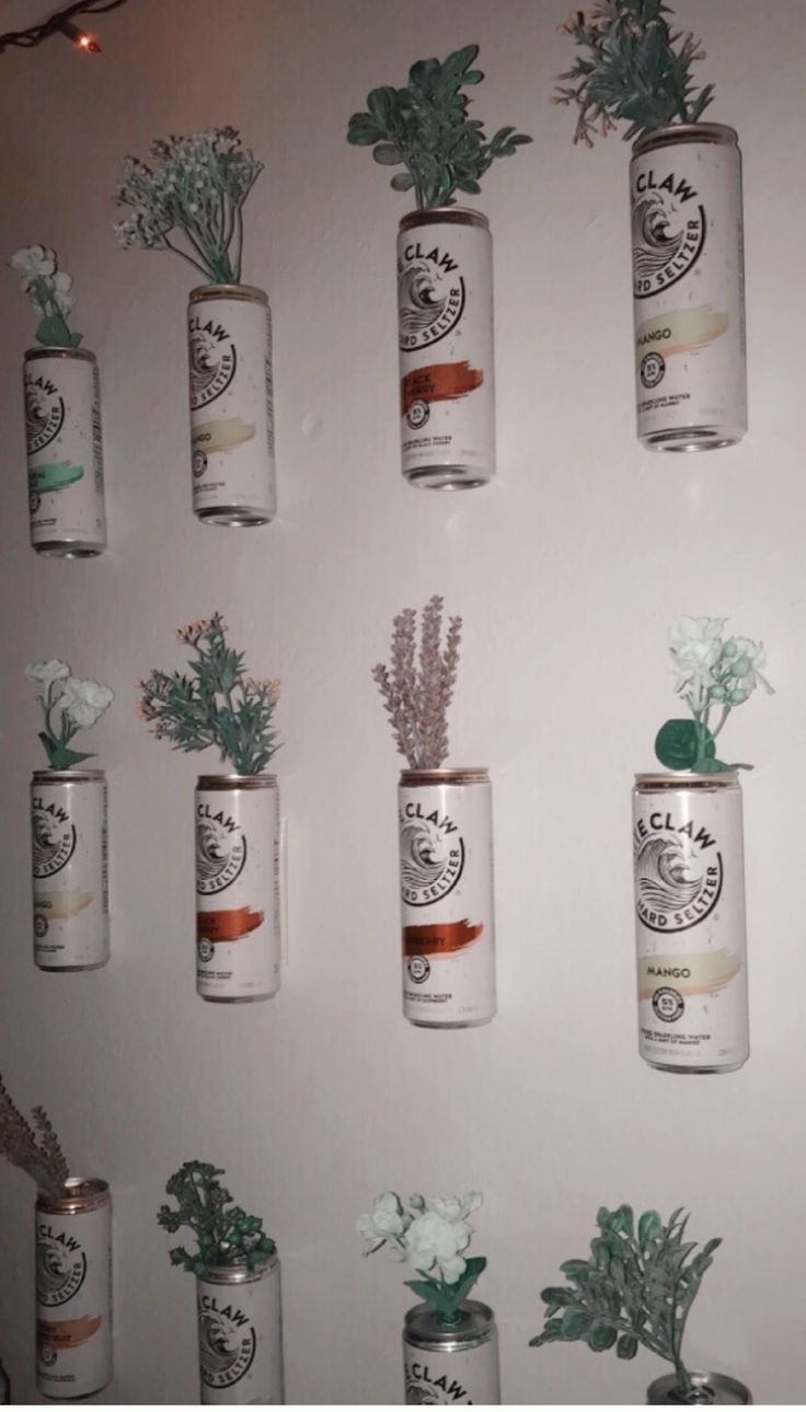 the wall is decorated with flowers and plants in mason jar vases on it's sides