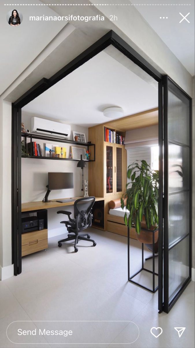 an open room with a desk, chair and bookshelf