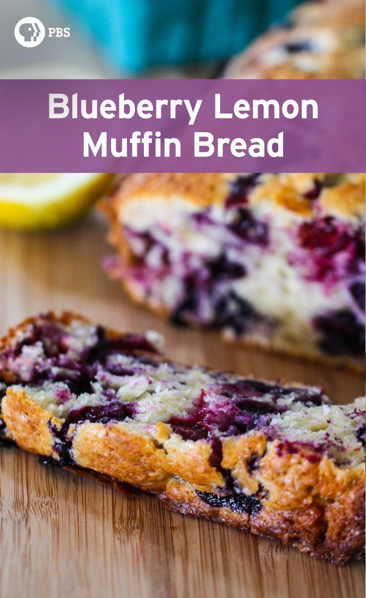 blueberry lemon muffin bread on a cutting board with a slice cut from it