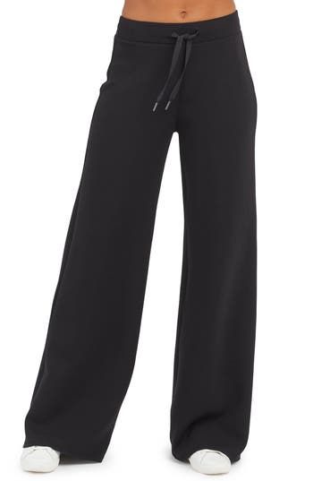 These throw-on-and-go pants is made from spacer fabric that's engineered with a cushiony feel that's as light as air. 30" inseam, 26" leg opening, 12" front rise, 15" back rise (size medium) Elastic/drawstring waist 47% modal, 46% polyester, 7% elastane Machine wash, tumble dry Imported Wide Comfy Pants, Black Womens Dress Pants, Straight Leg Sweat Pants, Black Comfy Pants, Dream Clothes Pants, Winter Workout Clothes, Open Leg Sweatpants, Black Wide Leg Sweatpants, Black Baggy Sweatpants