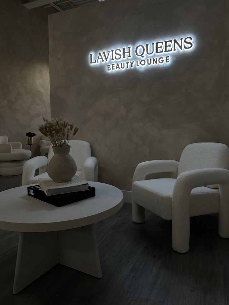 a room with chairs, tables and a sign that says lavish queens beauti lounge