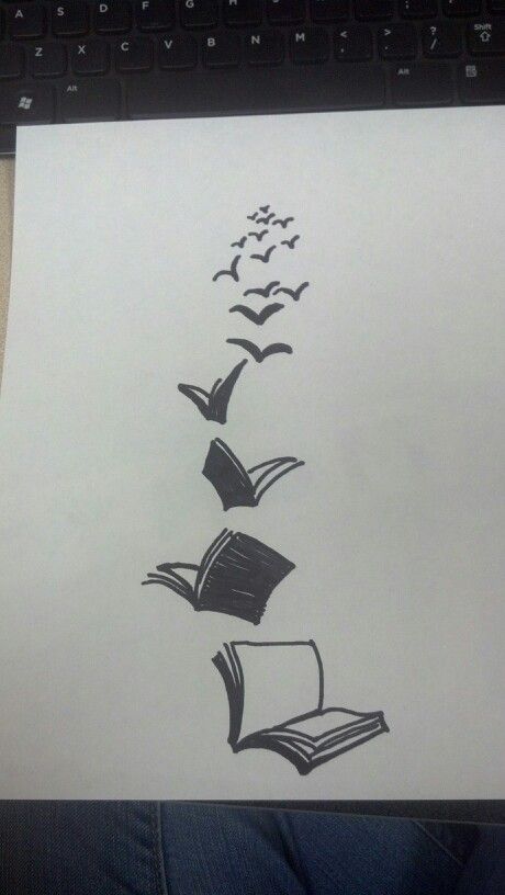 a drawing of an open book with flying birds coming out of it, on top of a sheet of paper