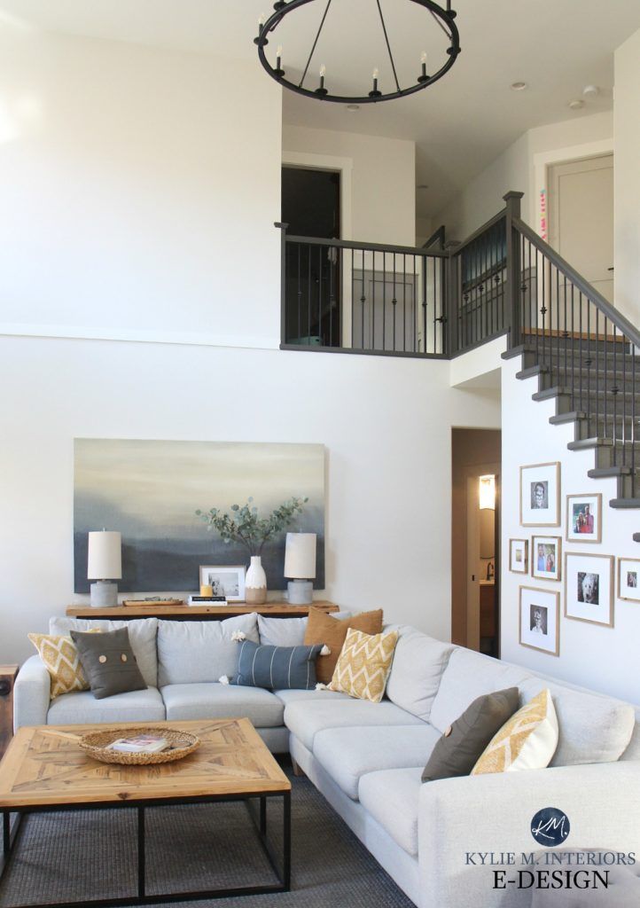 a living room filled with furniture and a spiral staircase leading up to the second floor